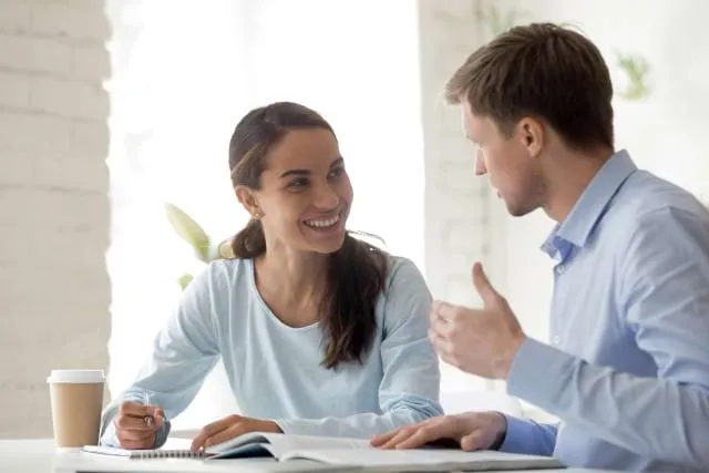 A male tutor explaining something to a female student